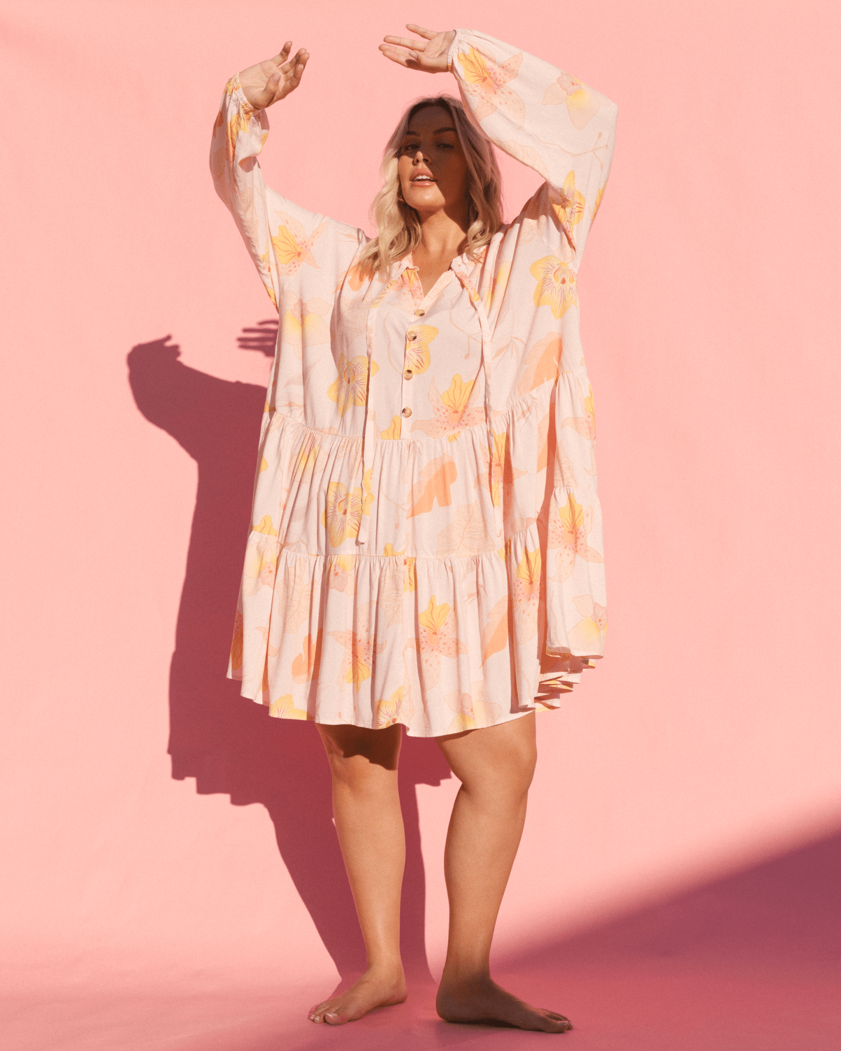 Woman wearing oversized long sleeve smock dress.