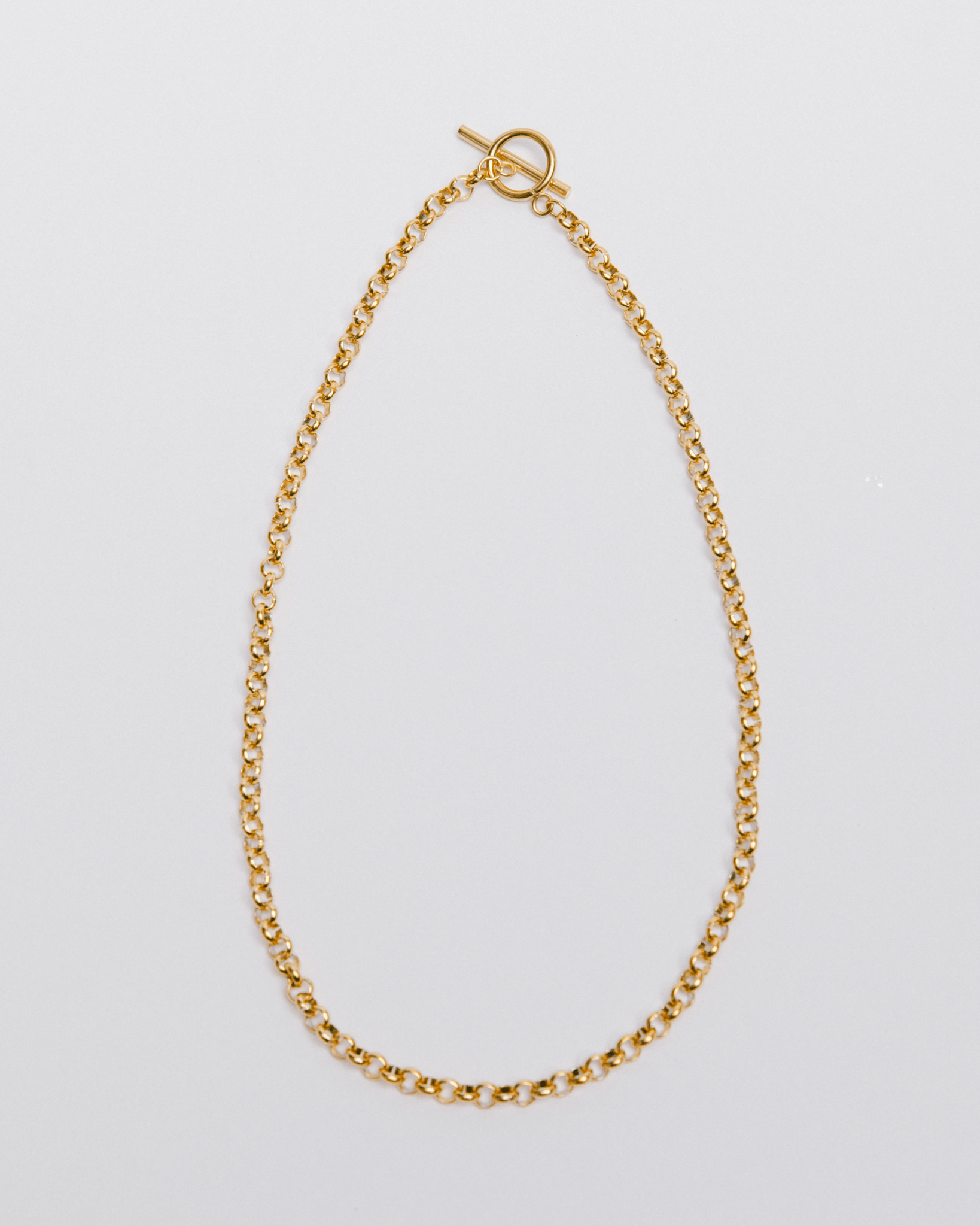 A chunky gold toggle necklace with a classic chain design, displayed against a white background.