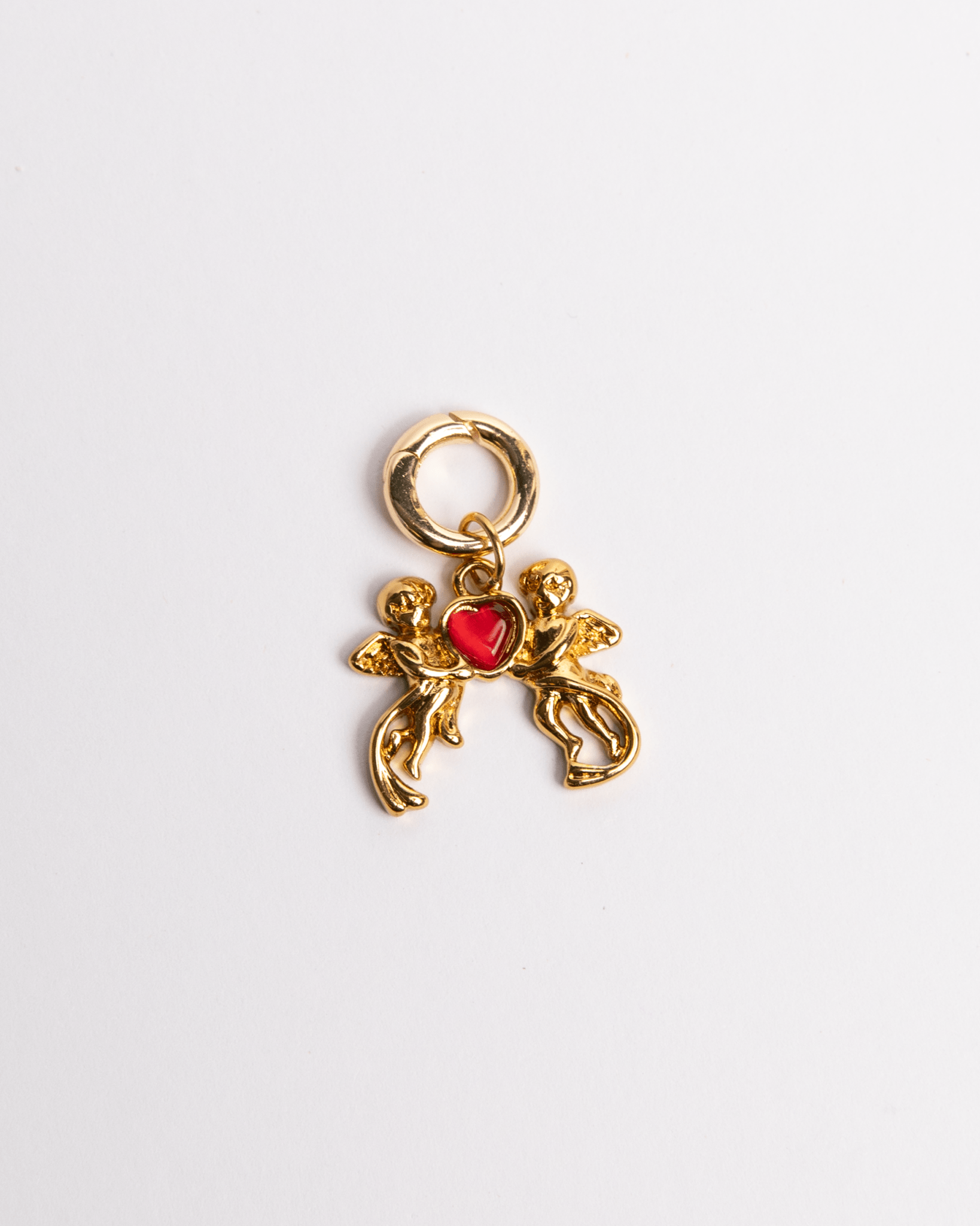 A gold-plated stainless steel charm featuring a silhouette of Cupid with a bow and a red heart.