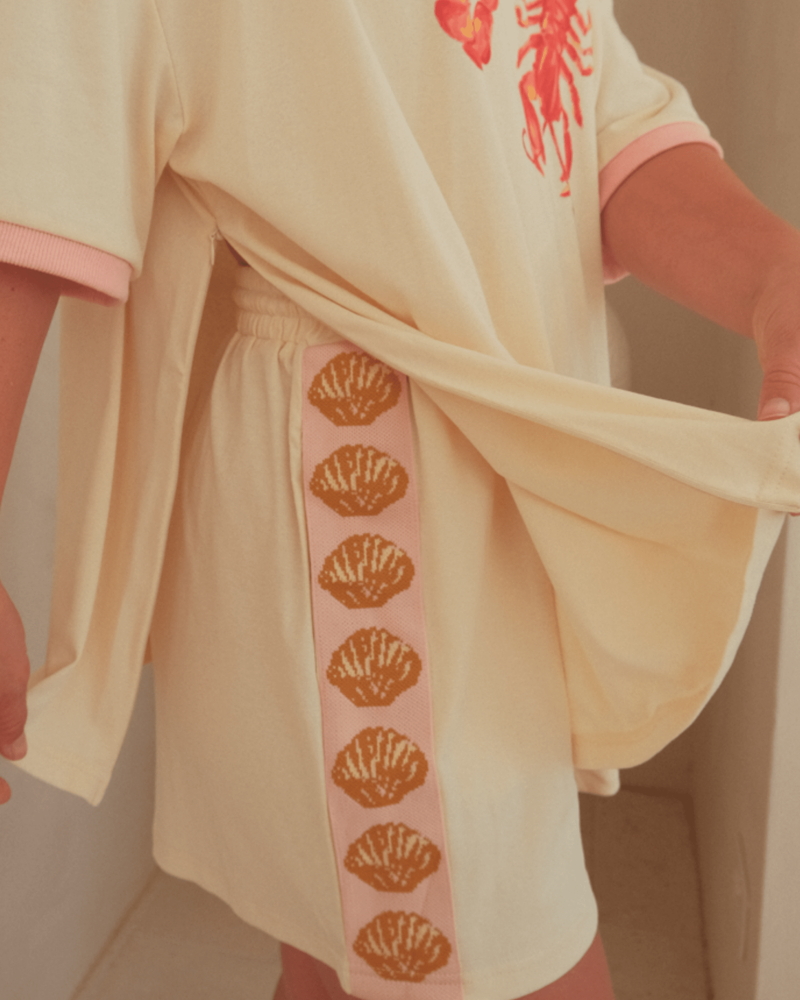 Close-up of breastfeeding friendly zippers on the side-seams of oversized t-shirt.