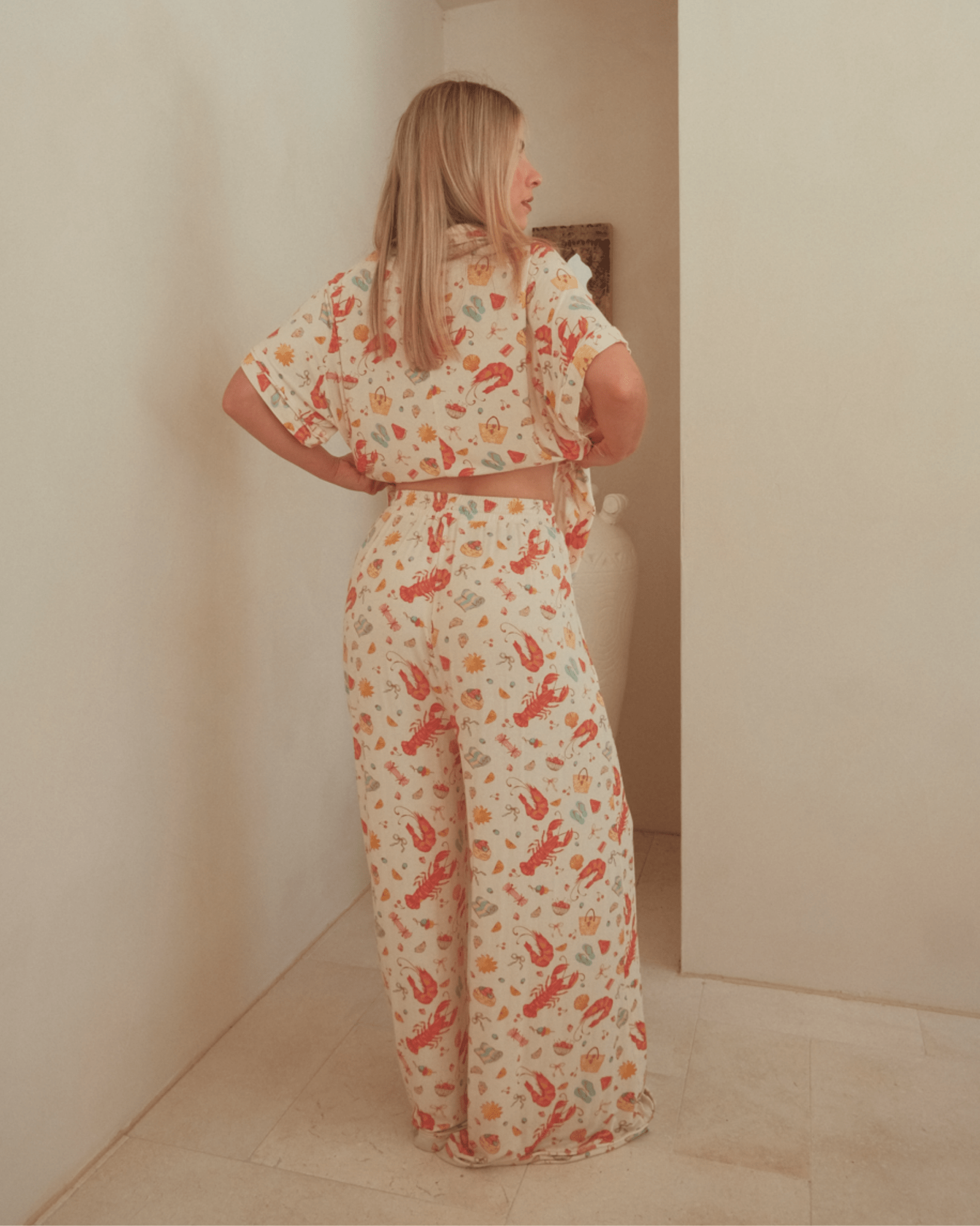 Woman wearing a matching christmas pj set featuring a breathable short sleeved shirt and long pants.