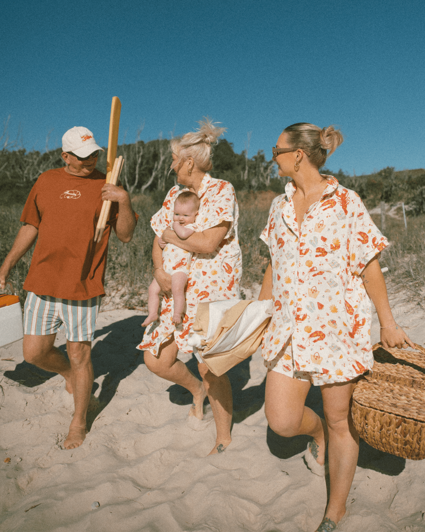 Family of four on a beach with a clear blue sky