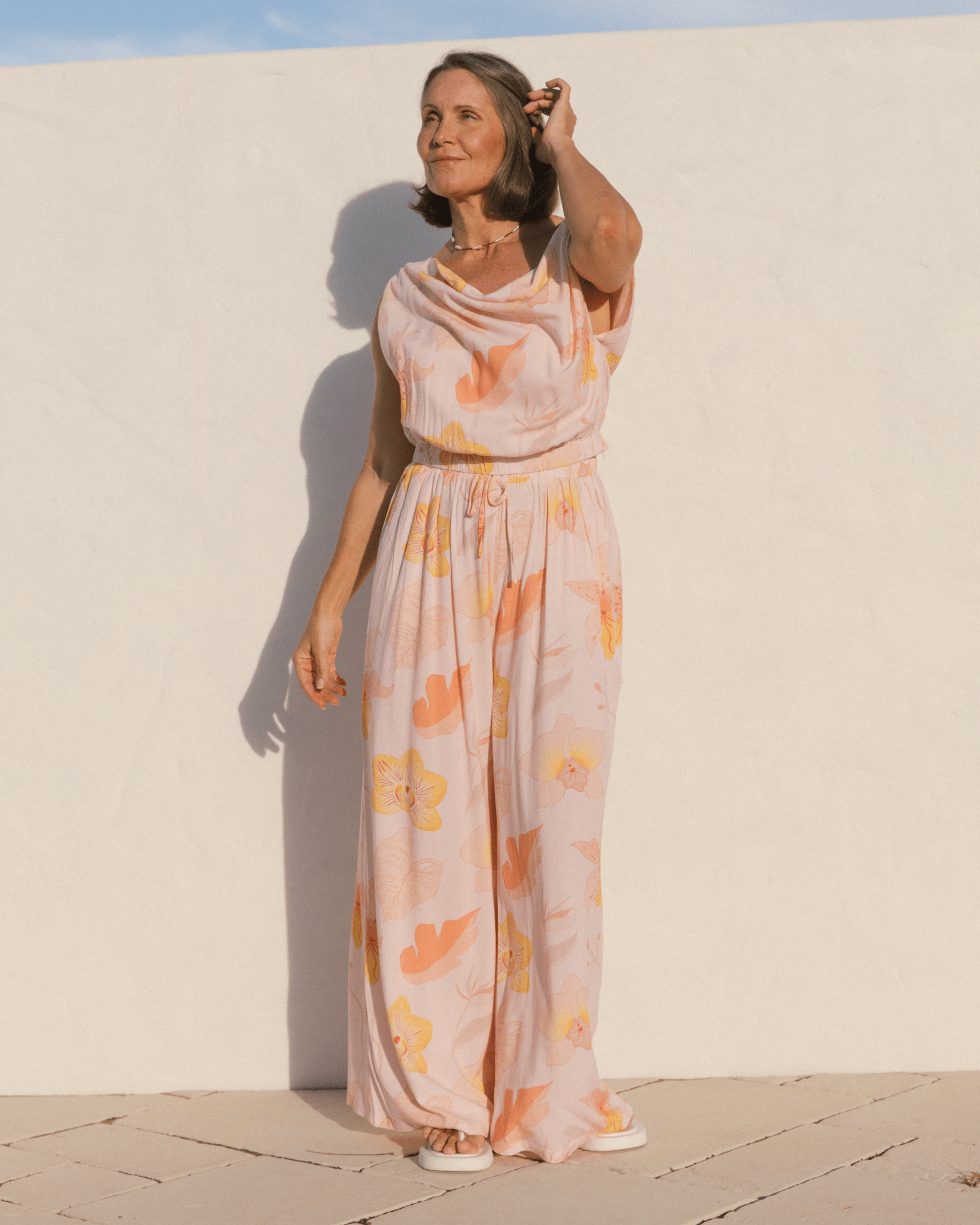 Woman wearing boat neck crop top and high-waister matching pants