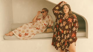 Three women wearing linen printed sets, relaxed sitting on stairs outside in a fashionable manner