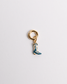 A blue boot charm with a gold-colored clasp and detailing on a white background.