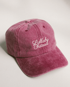 Distressed denim wine coloured cap with 'Lullaby Cháteau' embriodered in cursive font