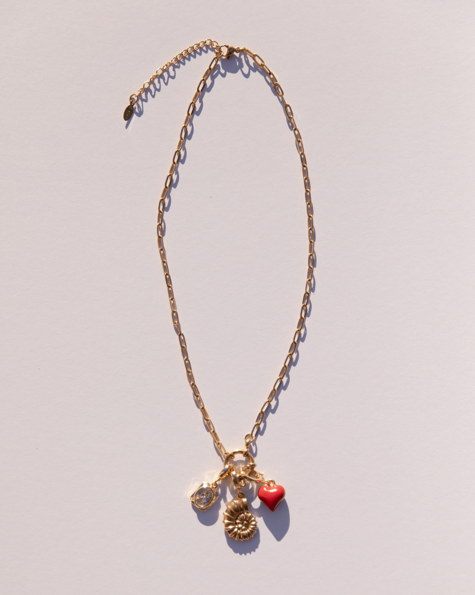 Gold plated chain link necklace with a range of charms attached