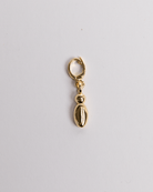 A gold-colored lowercase 'I" charm in a bubble style with a clasp, placed against a white background.