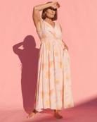 Woman wearing a maxi length spring time pink floral dress. 