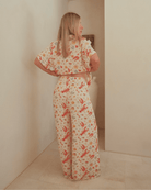 Woman wearing a matching christmas pj set featuring a breathable short sleeved shirt and long pants.