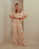 Woman wearing long, breathable pj pants with adjustable tie, waistband. 