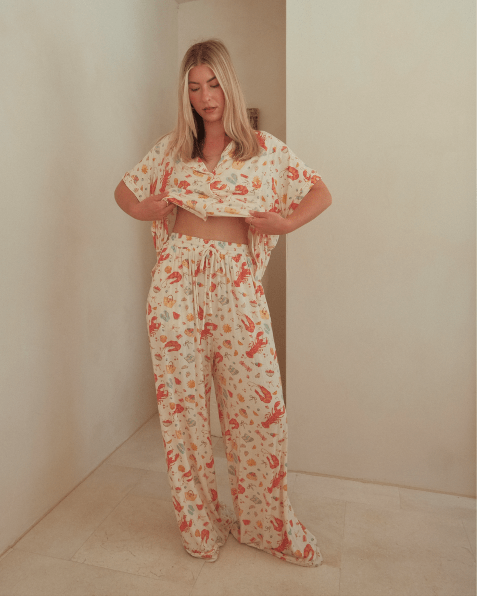 Woman wearing long, breathable pj pants with adjustable tie, waistband. 