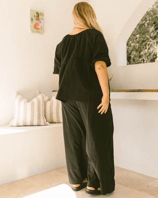 Pregnant woman wearing black maternity lounge pants - Posey Pants by The Lullaby Club