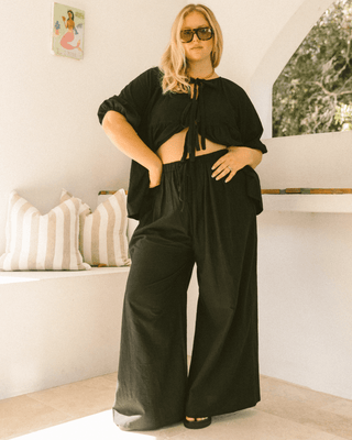 Pregnant woman wearing black maternity lounge pants - Posey Pants by The Lullaby Club