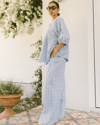 Side view of the Posey Pants in Blue Gingham, showcasing the flowy, breathable cotton fabric and roomy fit.