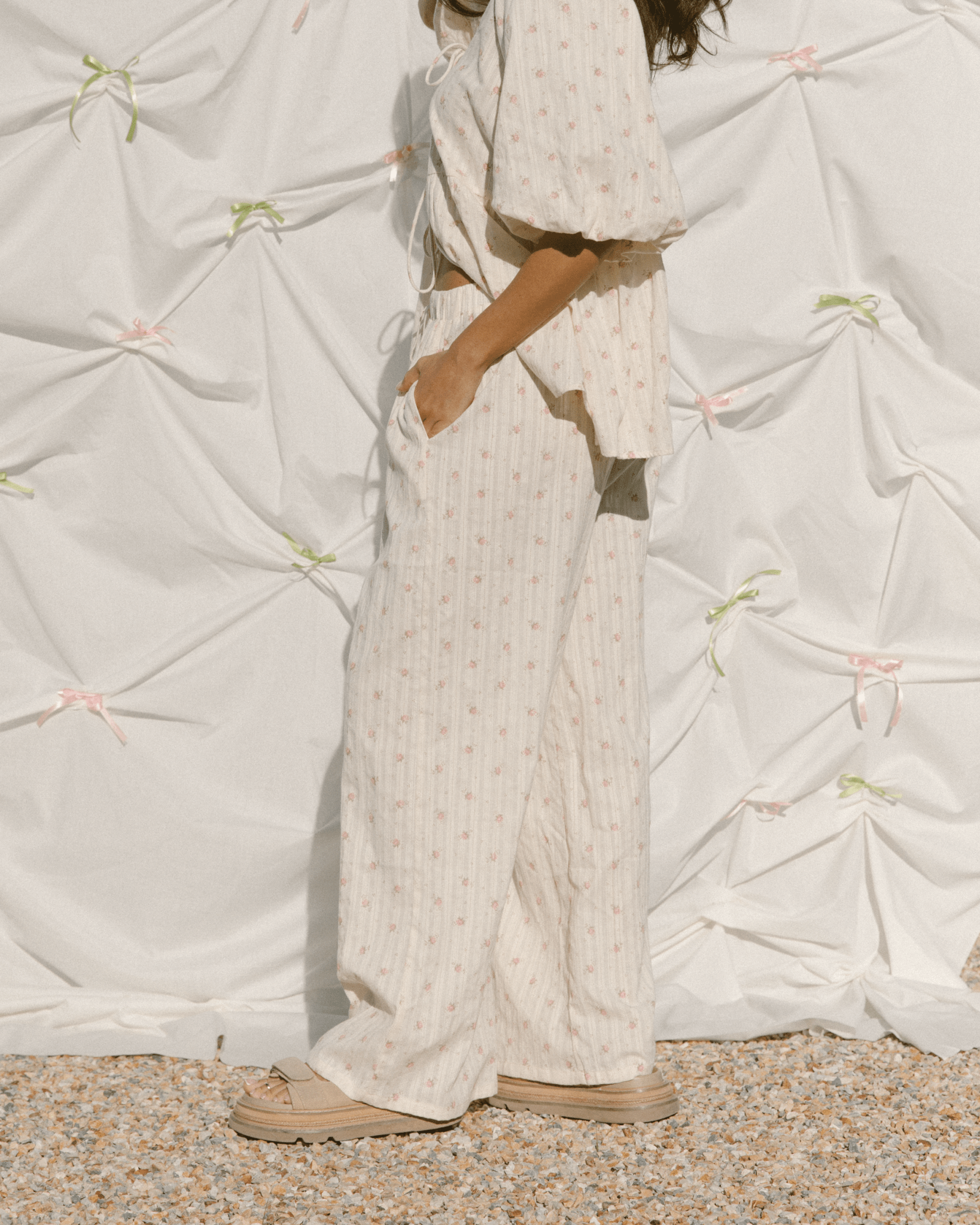 Close-up of wide-legged maternity pants with pockets and floral pattern. 