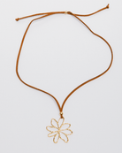 Necklace with a gold flower pendant on a white background